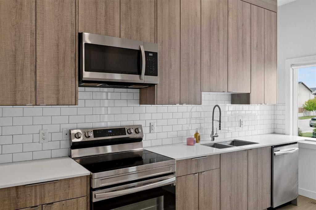202-101 Panatella Square Nw, Calgary, AB - Indoor Photo Showing Kitchen With Stainless Steel Kitchen With Double Sink With Upgraded Kitchen