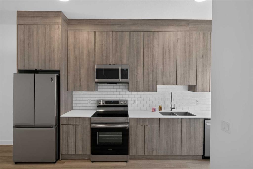202-101 Panatella Square Nw, Calgary, AB - Indoor Photo Showing Kitchen With Double Sink