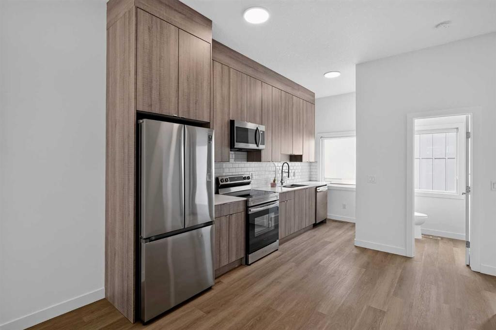 202-101 Panatella Square Nw, Calgary, AB - Indoor Photo Showing Kitchen With Stainless Steel Kitchen