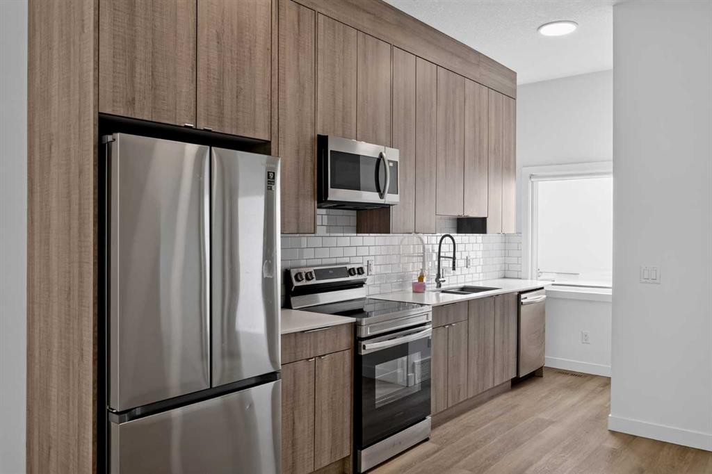 202-101 Panatella Square Nw, Calgary, AB - Indoor Photo Showing Kitchen With Stainless Steel Kitchen With Upgraded Kitchen