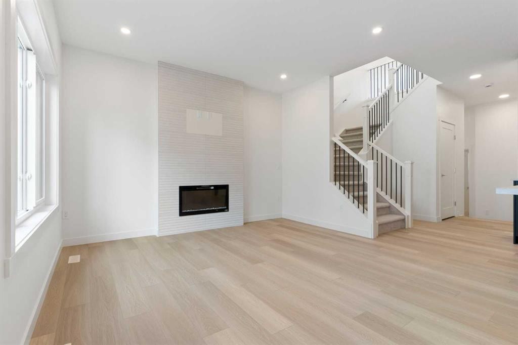 91 Heritage Manor, Cochrane, AB - Indoor With Fireplace