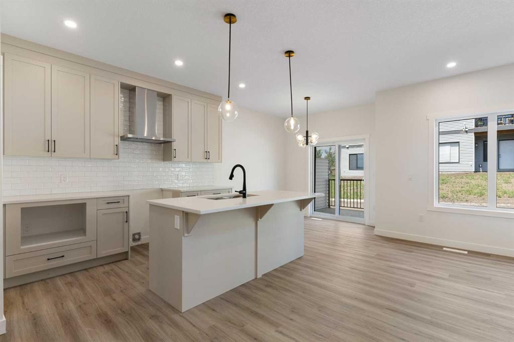 83 Heritage Manor, Cochrane, AB - Indoor Photo Showing Kitchen With Upgraded Kitchen