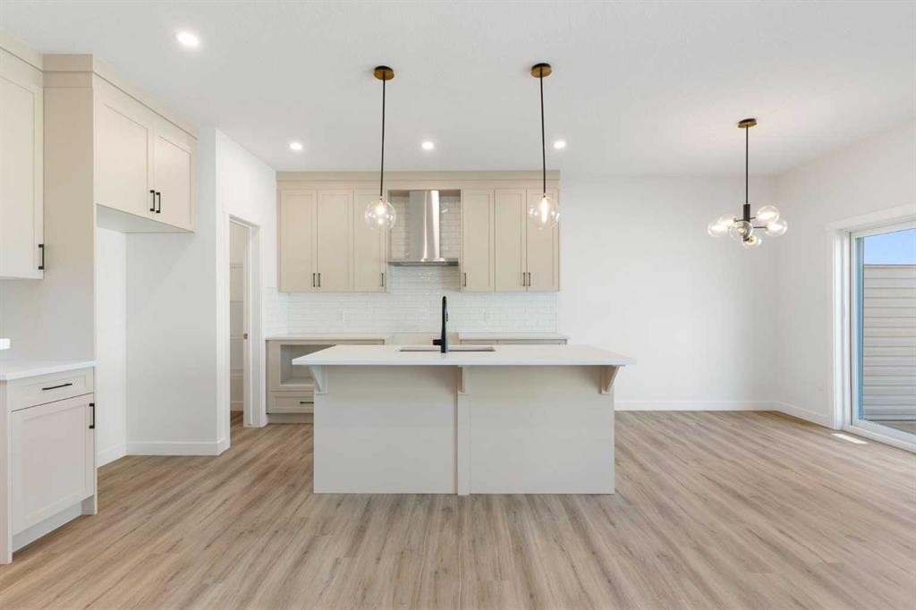 83 Heritage Manor, Cochrane, AB - Indoor Photo Showing Kitchen With Upgraded Kitchen