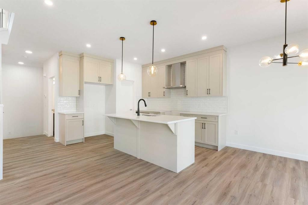 83 Heritage Manor, Cochrane, AB - Indoor Photo Showing Kitchen With Upgraded Kitchen
