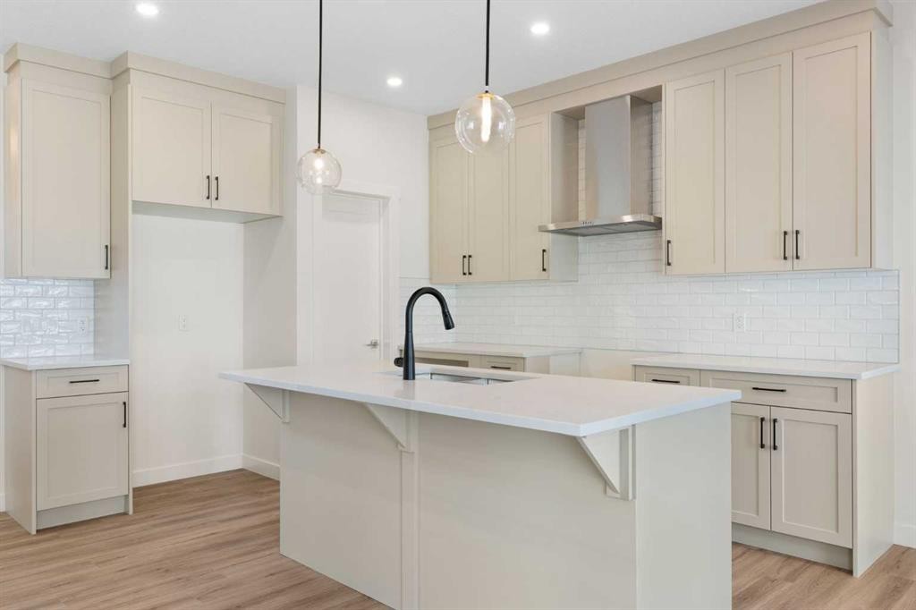 83 Heritage Manor, Cochrane, AB - Indoor Photo Showing Kitchen With Upgraded Kitchen
