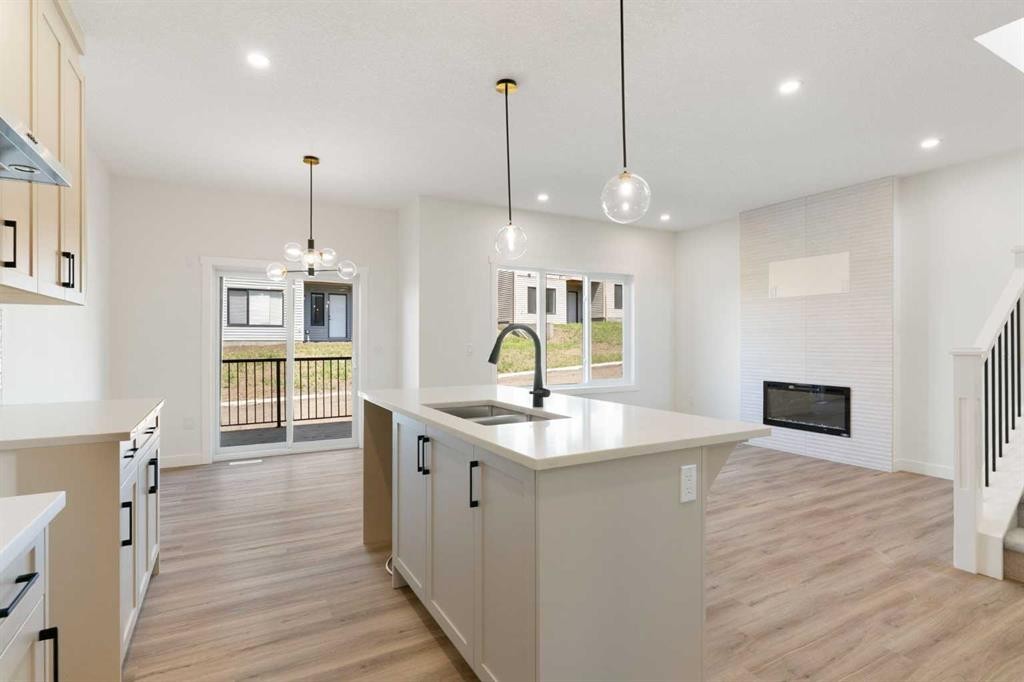 83 Heritage Manor, Cochrane, AB - Indoor Photo Showing Kitchen With Double Sink With Upgraded Kitchen