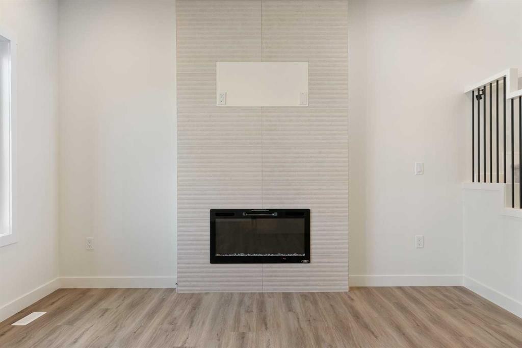 83 Heritage Manor, Cochrane, AB - Indoor With Fireplace