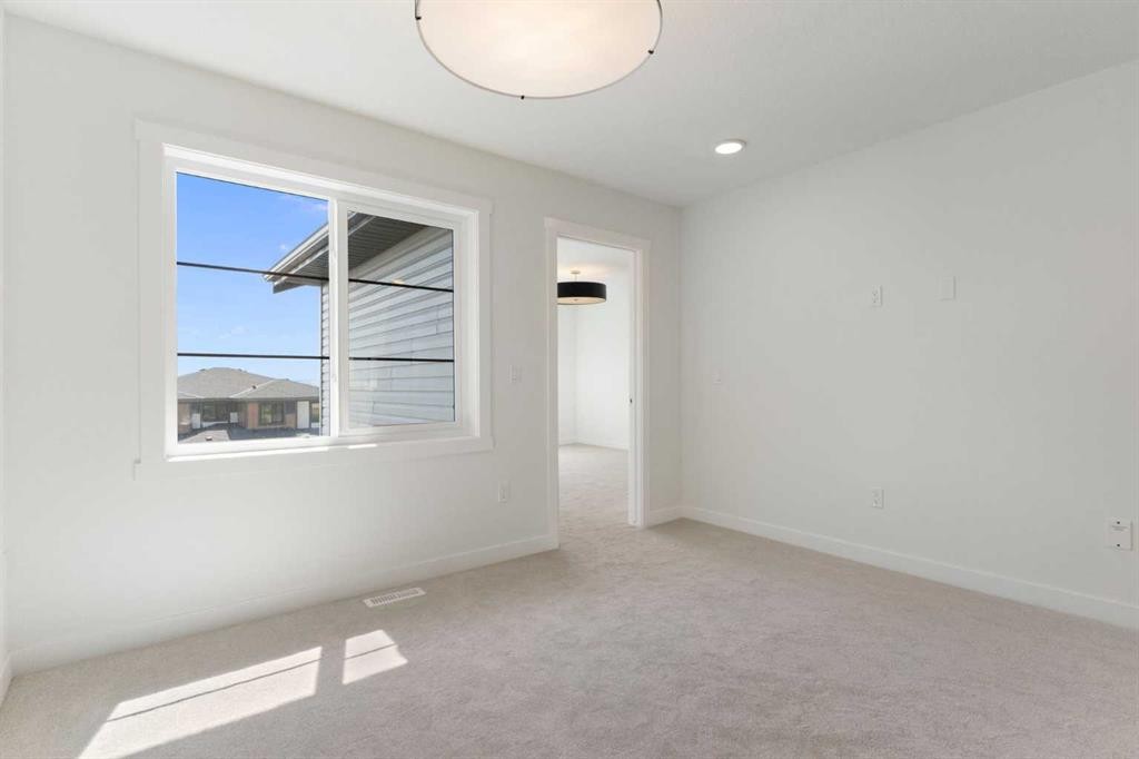 83 Heritage Manor, Cochrane, AB - Indoor Photo Showing Other Room