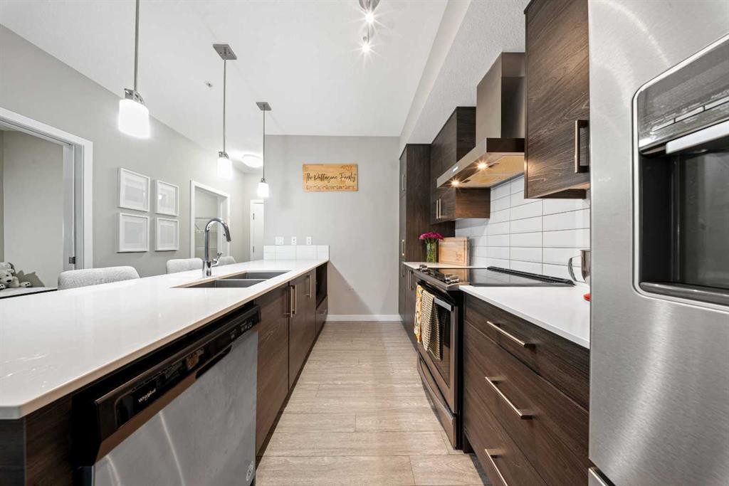 105-2231 Mahogany Boulevard Se, Calgary, AB - Indoor Photo Showing Kitchen With Stainless Steel Kitchen With Double Sink With Upgraded Kitchen