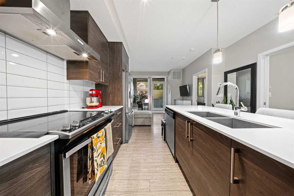 105-2231 Mahogany Boulevard Se, Calgary, AB - Indoor Photo Showing Kitchen With Double Sink With Upgraded Kitchen