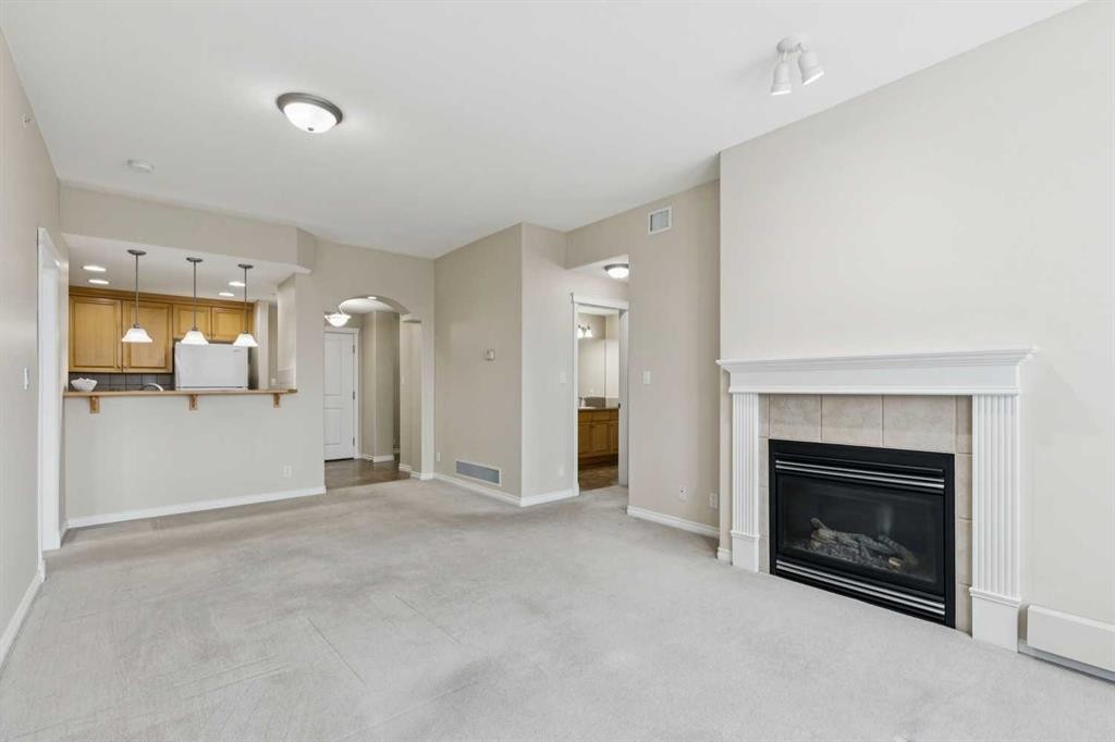 705-1726 14 Avenue Nw, Calgary, AB - Indoor Photo Showing Living Room With Fireplace