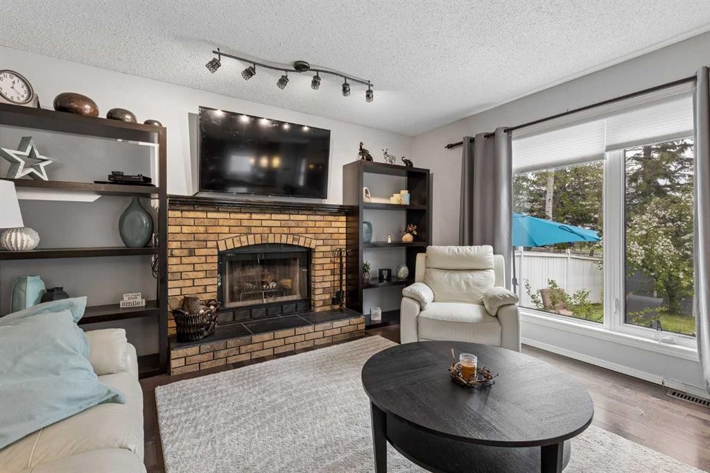 244 Scurfield Place Nw, Calgary, AB - Indoor Photo Showing Living Room With Fireplace