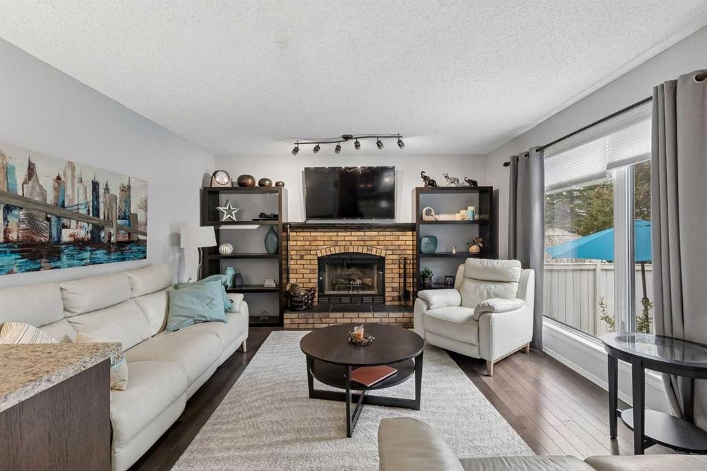 244 Scurfield Place Nw, Calgary, AB - Indoor Photo Showing Living Room With Fireplace