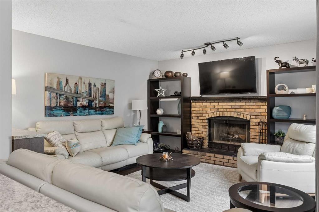 244 Scurfield Place Nw, Calgary, AB - Indoor Photo Showing Living Room With Fireplace