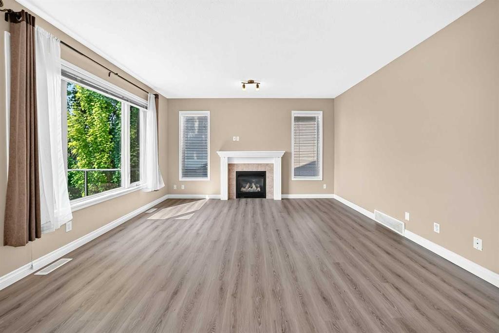 63 Royal Birch Point Nw, Calgary, AB - Indoor Photo Showing Living Room With Fireplace