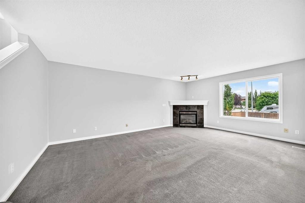 171 Oakmere Green, Chestermere, AB - Indoor Photo Showing Living Room With Fireplace