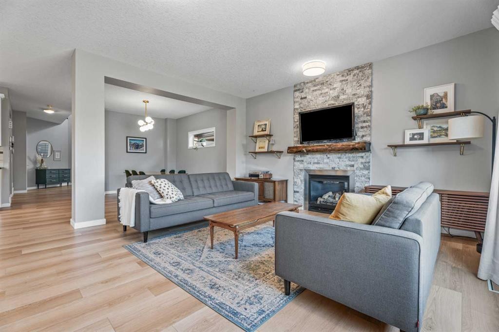 6 Storm Mountain Place, Okotoks, AB - Indoor Photo Showing Living Room With Fireplace