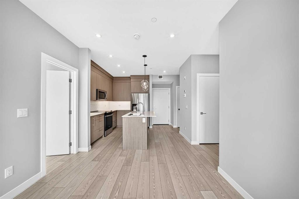 2110-6 Merganser Drive West, Chestermere, AB - Indoor Photo Showing Kitchen With Stainless Steel Kitchen