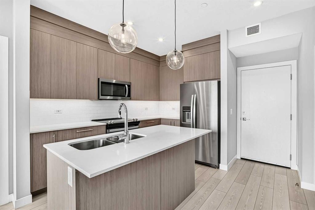 2110-6 Merganser Drive West, Chestermere, AB - Indoor Photo Showing Kitchen With Stainless Steel Kitchen With Double Sink With Upgraded Kitchen