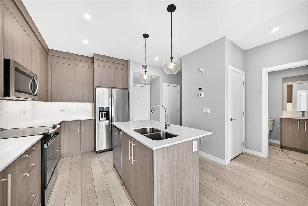 2110-6 Merganser Drive West, Chestermere, AB - Indoor Photo Showing Kitchen With Stainless Steel Kitchen With Double Sink With Upgraded Kitchen