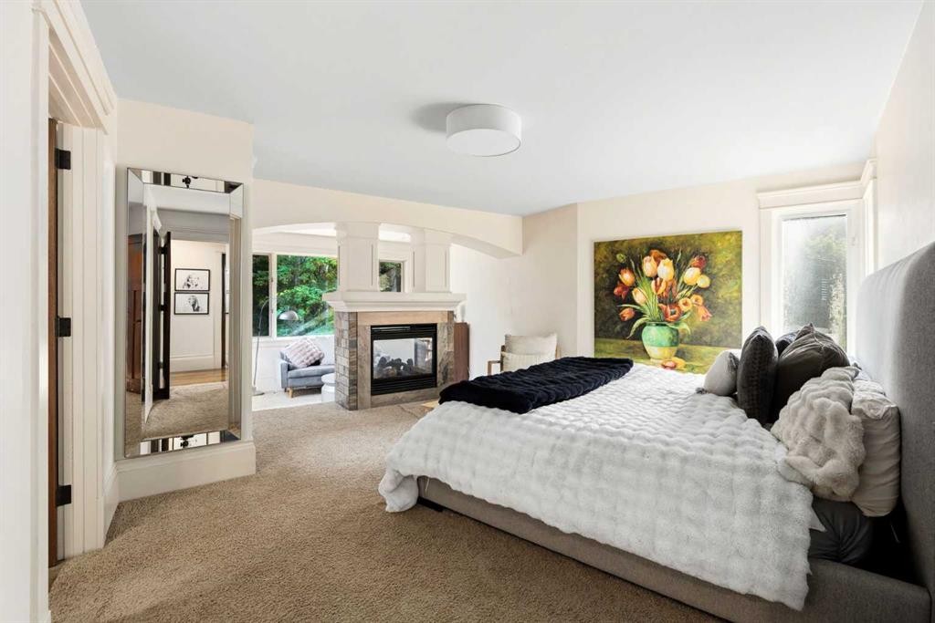15 Elbow River Point, Rural Rocky View County, AB - Indoor Photo Showing Bedroom With Fireplace