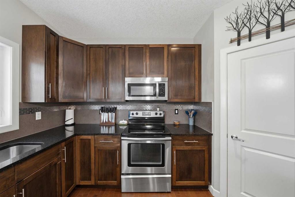 4 Drake Landing Gate, Okotoks, AB - Indoor Photo Showing Kitchen With Stainless Steel Kitchen