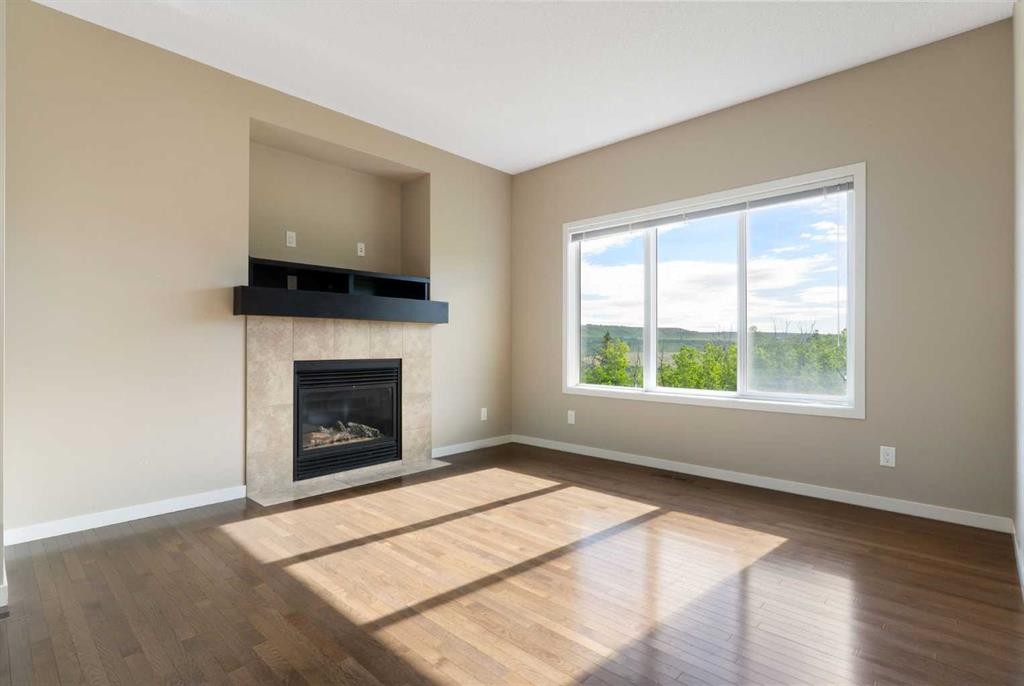 638 River Heights Crescent, Cochrane, AB - Indoor Photo Showing Living Room With Fireplace