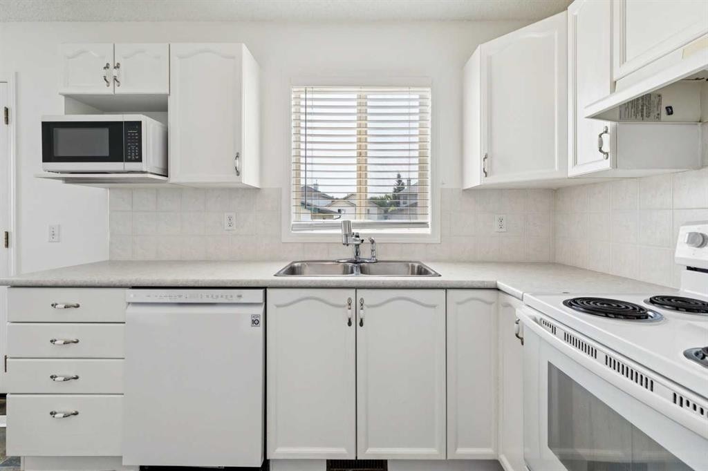 25 Coville Gardens Ne, Calgary, AB - Indoor Photo Showing Kitchen With Double Sink