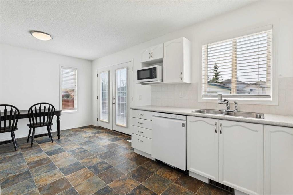 25 Coville Gardens Ne, Calgary, AB - Indoor Photo Showing Kitchen With Double Sink