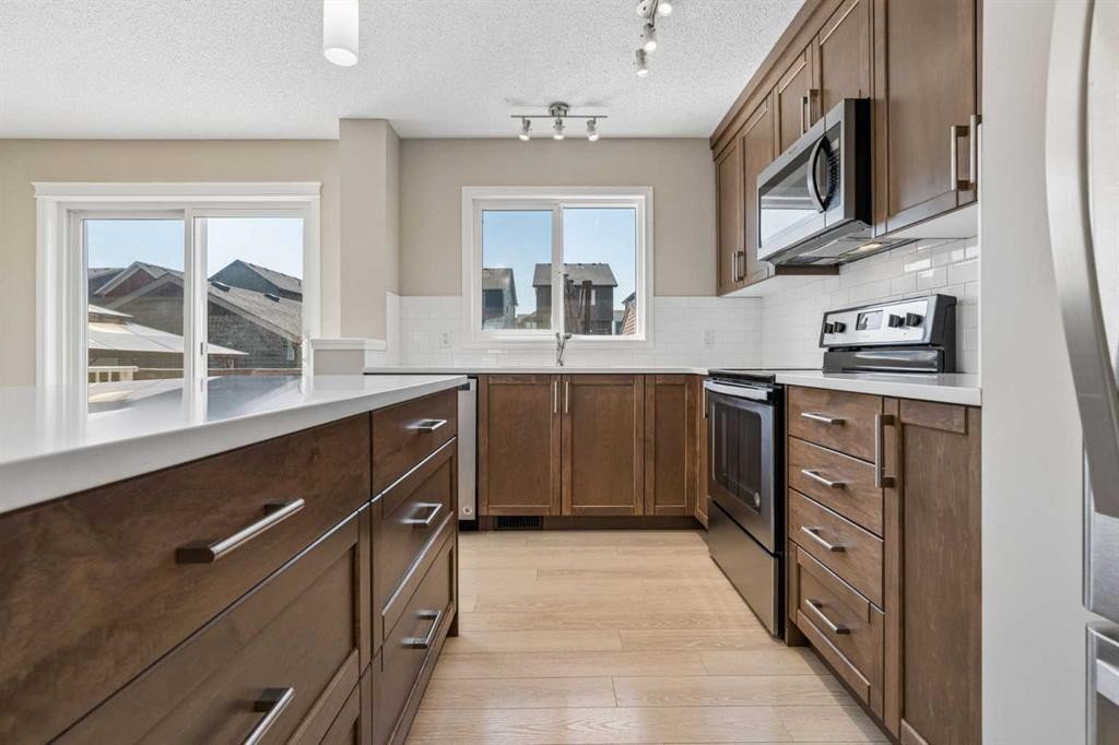 229 Fireside Drive, Cochrane, AB - Indoor Photo Showing Kitchen With Upgraded Kitchen