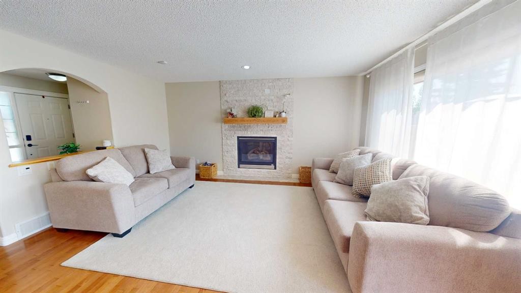 47 Chapman Circle Se, Calgary, AB - Indoor Photo Showing Living Room With Fireplace