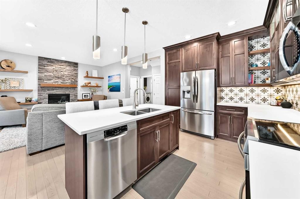 152 Royal Oak Terrace Nw, Calgary, AB - Indoor Photo Showing Kitchen With Fireplace With Double Sink With Upgraded Kitchen