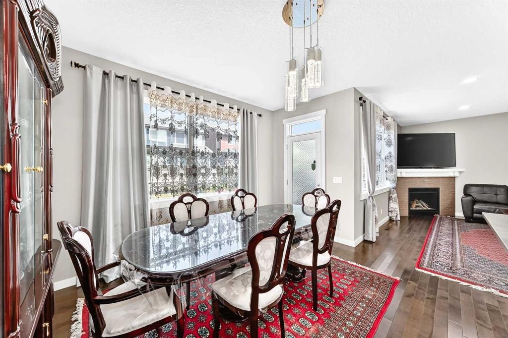 56 Evansborough Green Nw, Calgary, AB - Indoor Photo Showing Dining Room With Fireplace