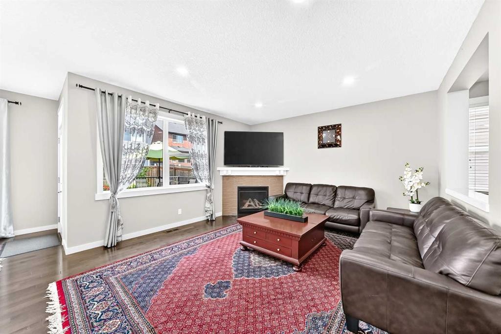56 Evansborough Green Nw, Calgary, AB - Indoor Photo Showing Living Room With Fireplace