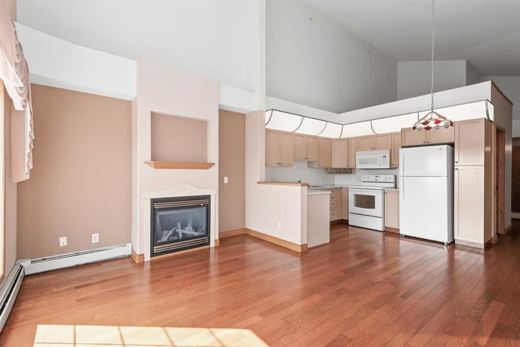 304-728 Country Hills Road Nw, Calgary, AB - Indoor Photo Showing Kitchen With Fireplace