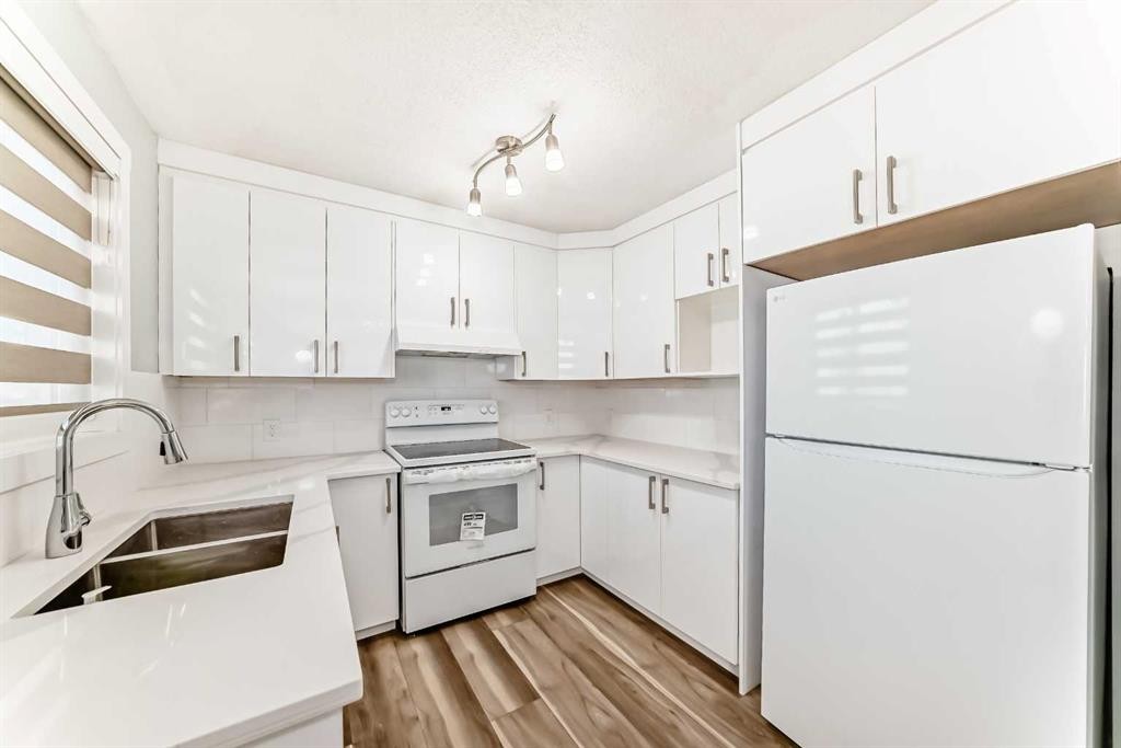 77 Martinbrook Road Ne, Calgary, AB - Indoor Photo Showing Kitchen With Double Sink