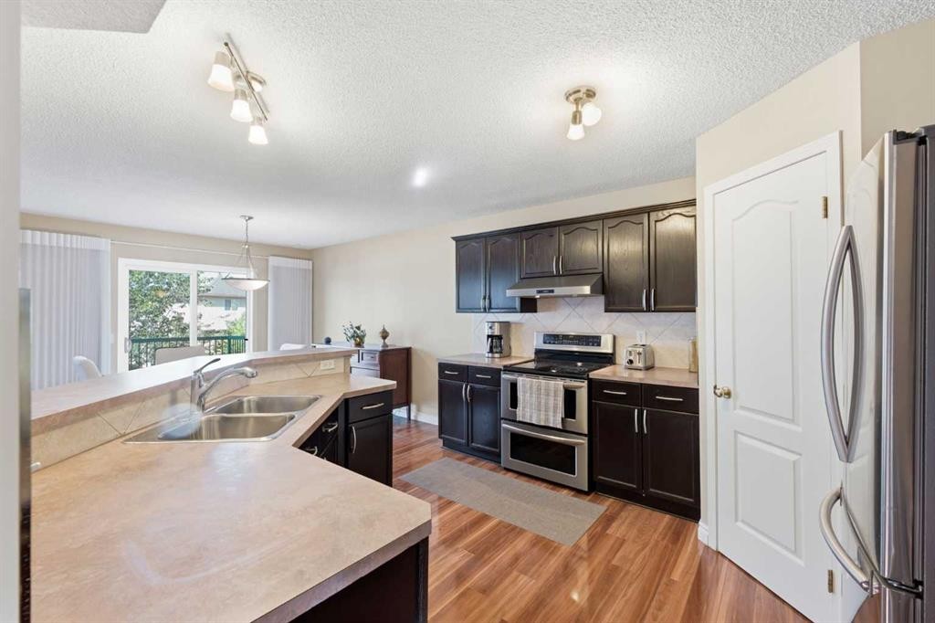 140 Arbour Stone Crescent Nw, Calgary, AB - Indoor Photo Showing Kitchen With Double Sink