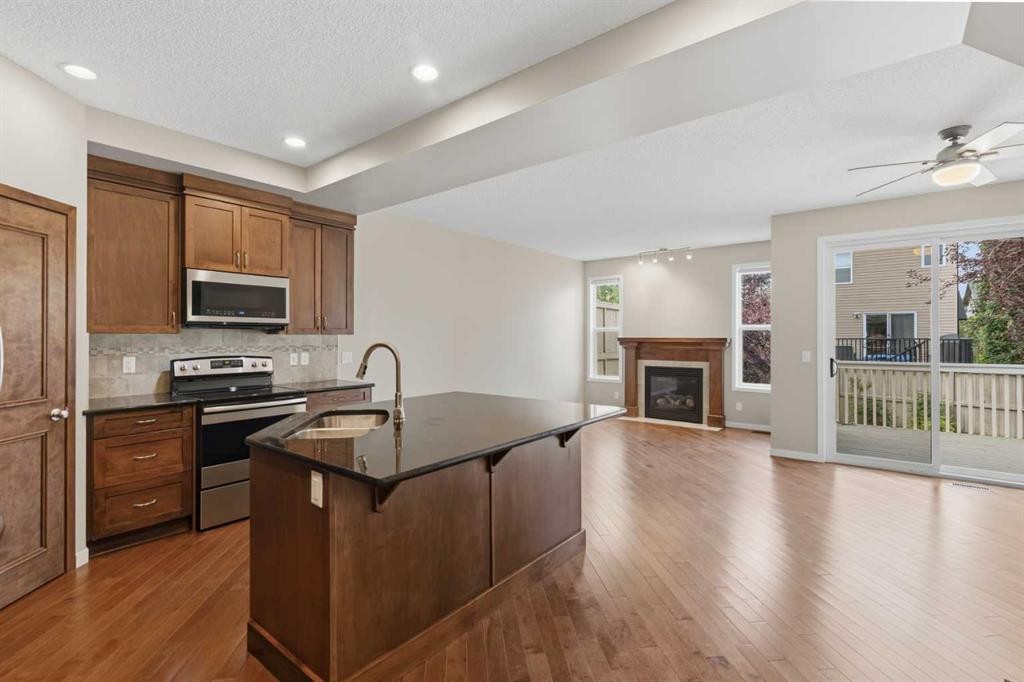 40 Panatella Mews Nw, Calgary, AB - Indoor Photo Showing Kitchen With Fireplace With Stainless Steel Kitchen