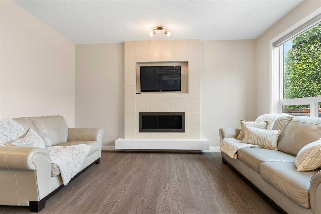 161 Cougar Ridge Close Sw, Calgary, AB - Indoor Photo Showing Living Room With Fireplace