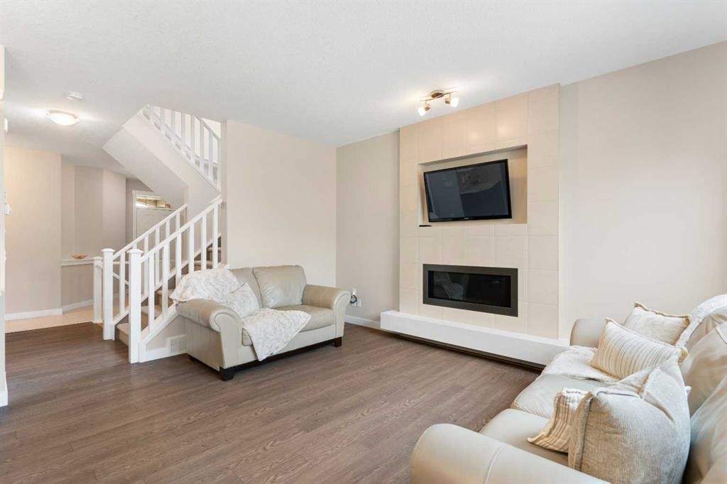 161 Cougar Ridge Close Sw, Calgary, AB - Indoor Photo Showing Living Room With Fireplace