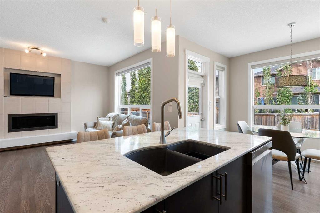 161 Cougar Ridge Close Sw, Calgary, AB - Indoor Photo Showing Kitchen With Fireplace With Double Sink