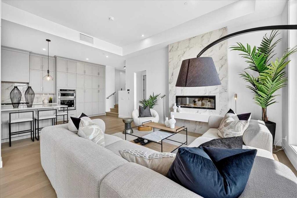 102-150 Marina Cove Se, Calgary, AB - Indoor Photo Showing Living Room With Fireplace