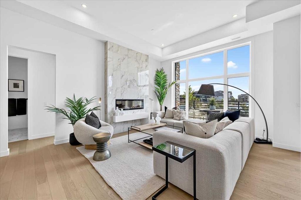 102-150 Marina Cove Se, Calgary, AB - Indoor Photo Showing Living Room With Fireplace