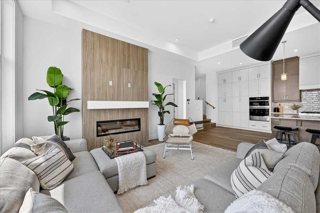 101-150 Marina Cove Se, Calgary, AB - Indoor Photo Showing Living Room With Fireplace