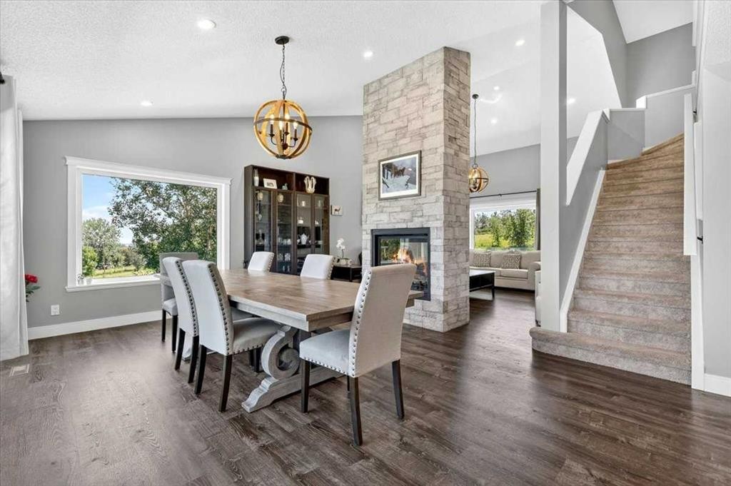 76-16044 258 Avenue East, Rural Foothills County, AB - Indoor Photo Showing Dining Room With Fireplace