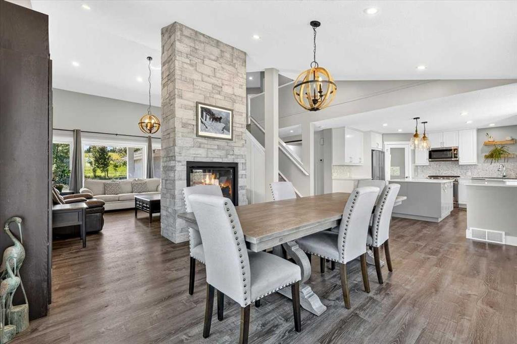 76-16044 258 Avenue East, Rural Foothills County, AB - Indoor Photo Showing Dining Room With Fireplace
