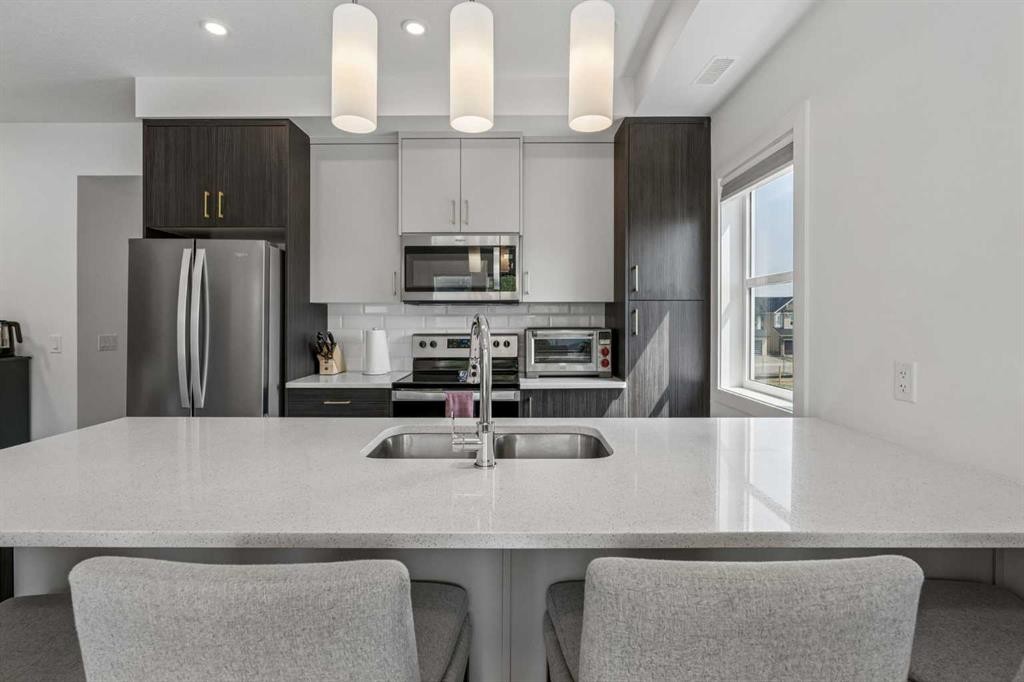 103 Spring Creek Common Sw, Calgary, AB - Indoor Photo Showing Kitchen With Double Sink With Upgraded Kitchen