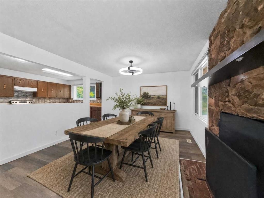 207 Deer Ridge Way Se, Calgary, AB - Indoor Photo Showing Dining Room With Fireplace