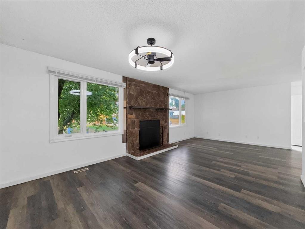 207 Deer Ridge Way Se, Calgary, AB - Indoor Photo Showing Living Room With Fireplace