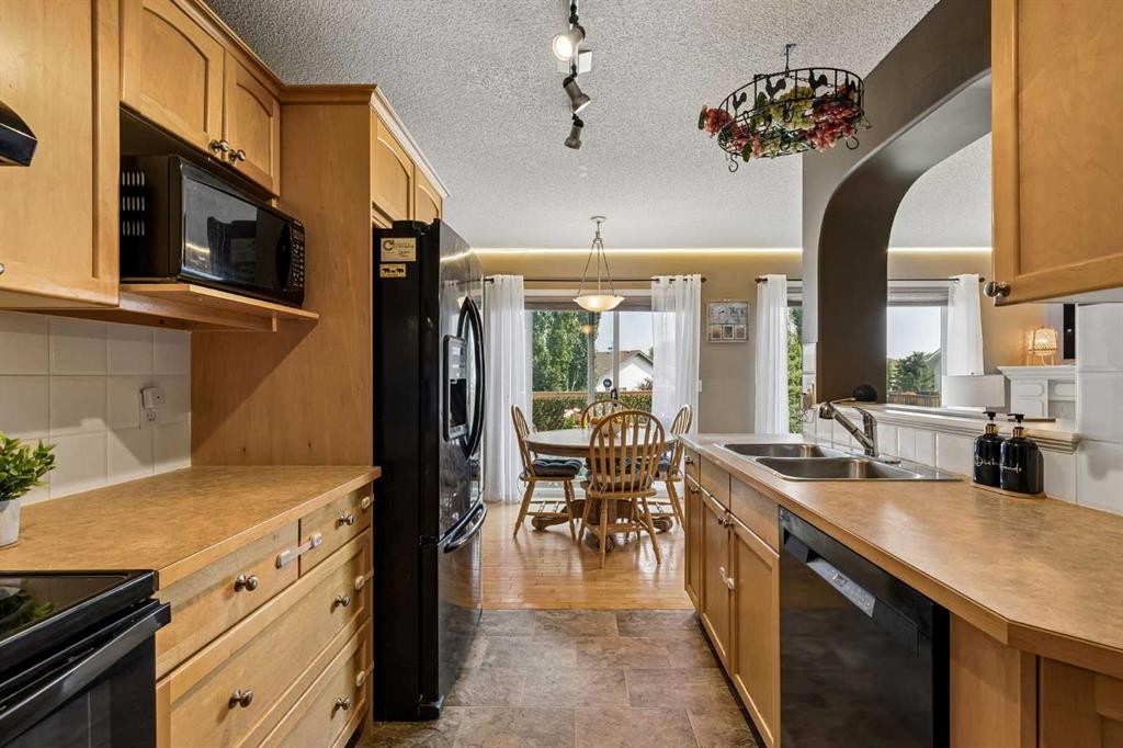 10-117 Bow Ridge Drive, Cochrane, AB - Indoor Photo Showing Kitchen With Double Sink